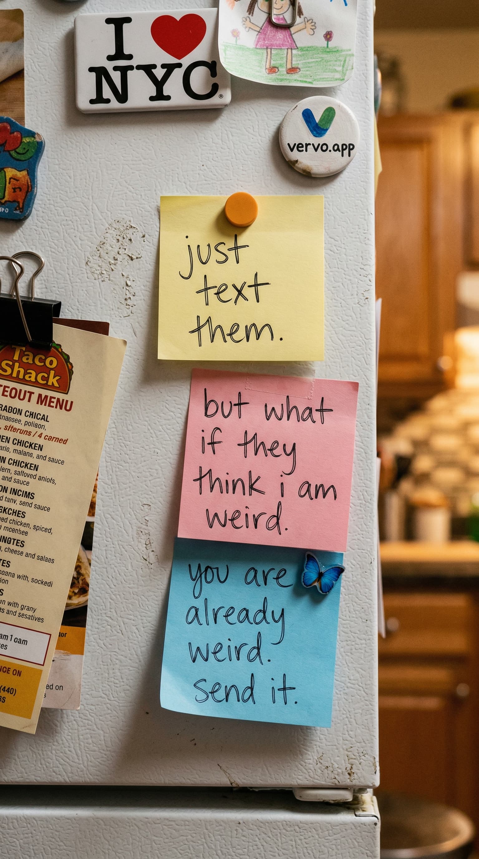Sticky notes on a fridge arguing with each other. One says just text them. Another says but what if they think i am weird. The third says you are already weird. send it.